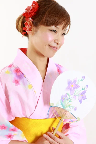 Young woman with paper Fan　 — Stock Photo, Image